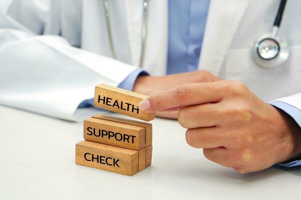 hand-holding-a-wooden-block-cube-the-top-one-with-word-and-icon-symbol-medical-and-health-concept-photo